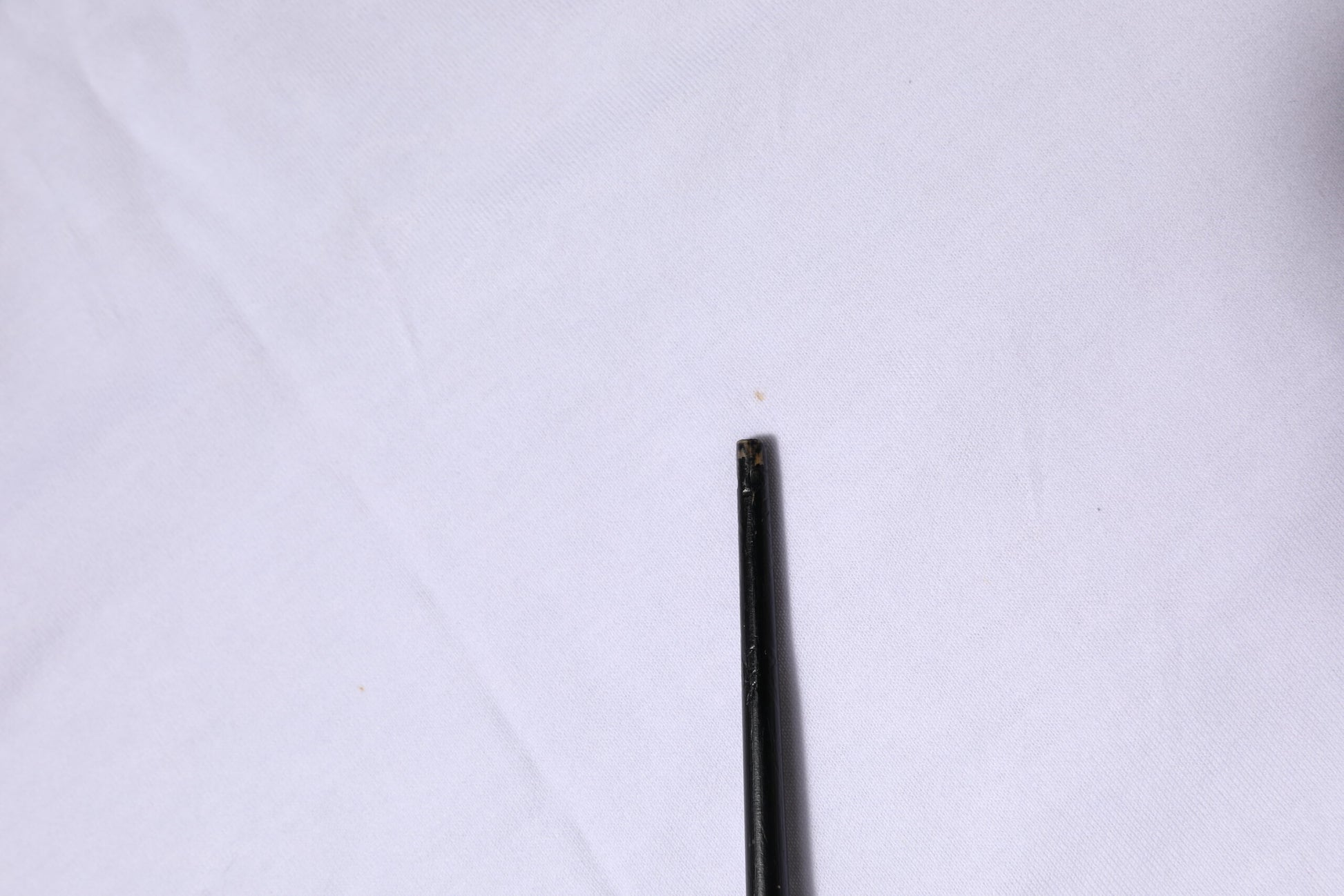 Black button on white fabric