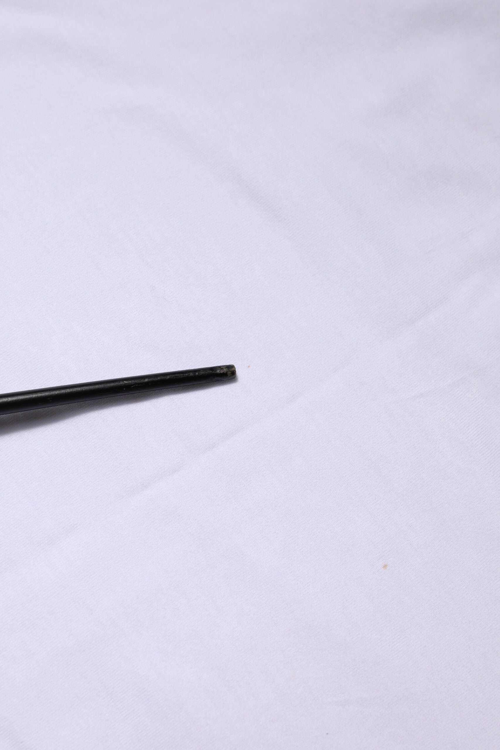 Small black object on white surface