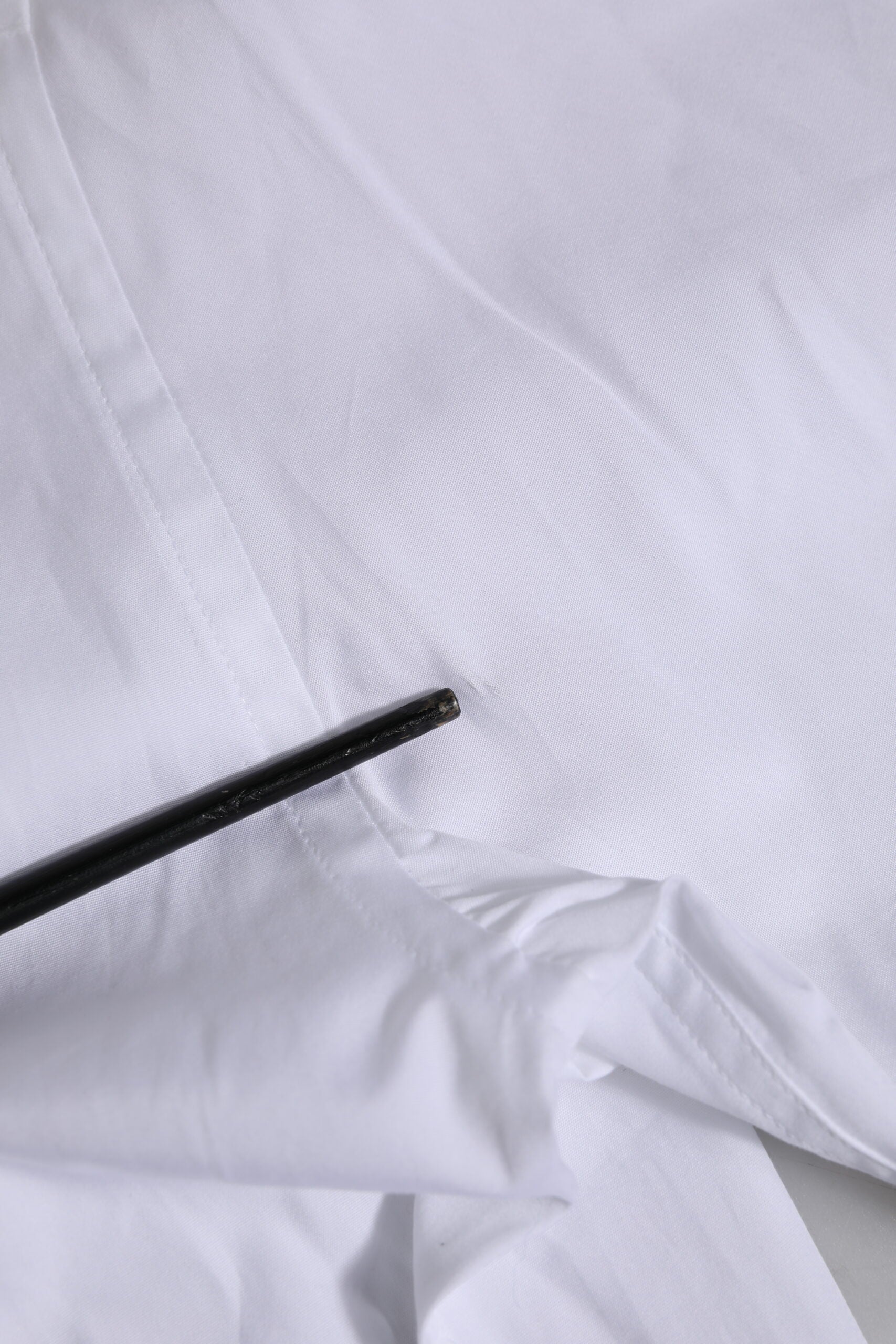 Black pen on white fabric