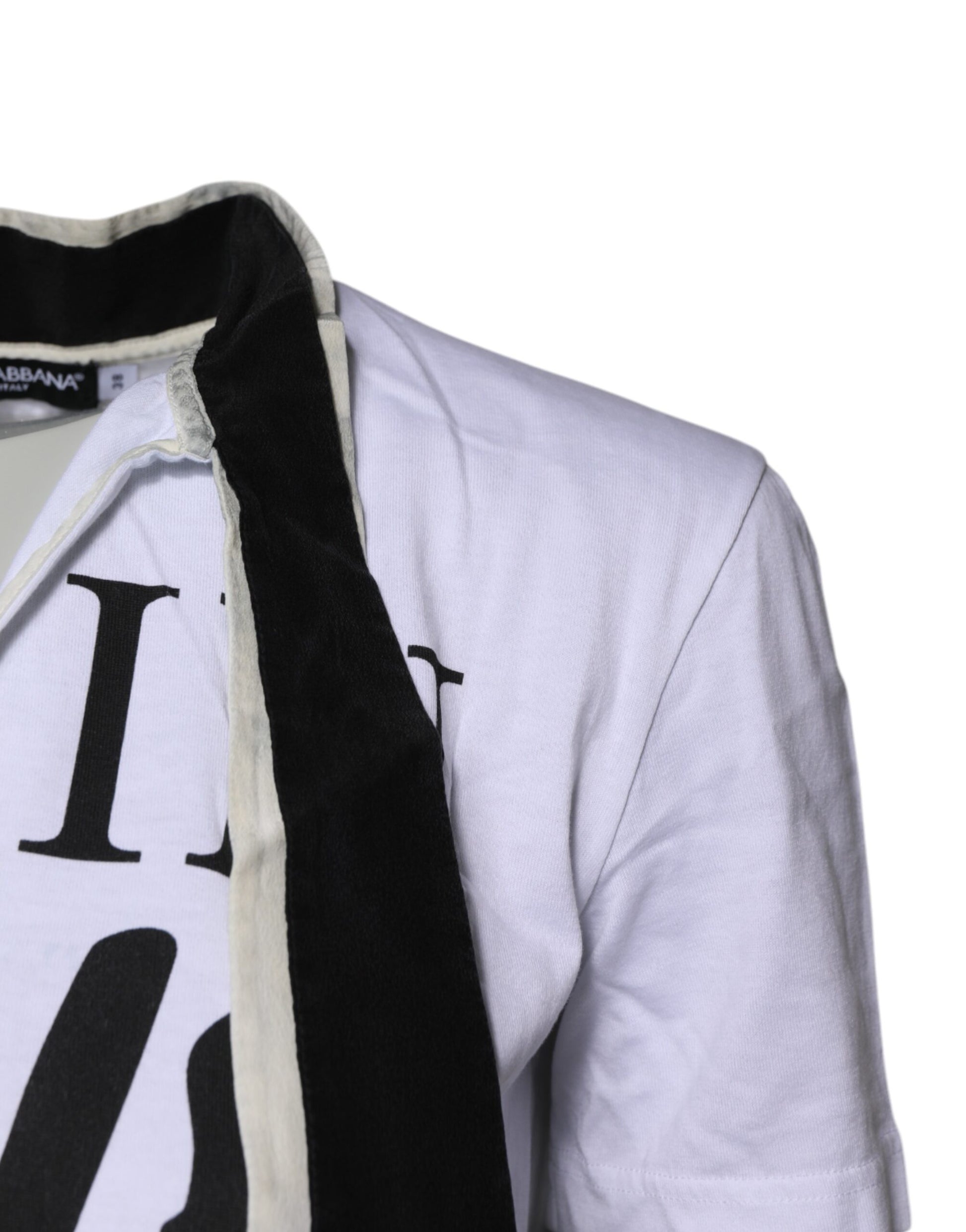 White jacket with black scarf hanging on a mannequin