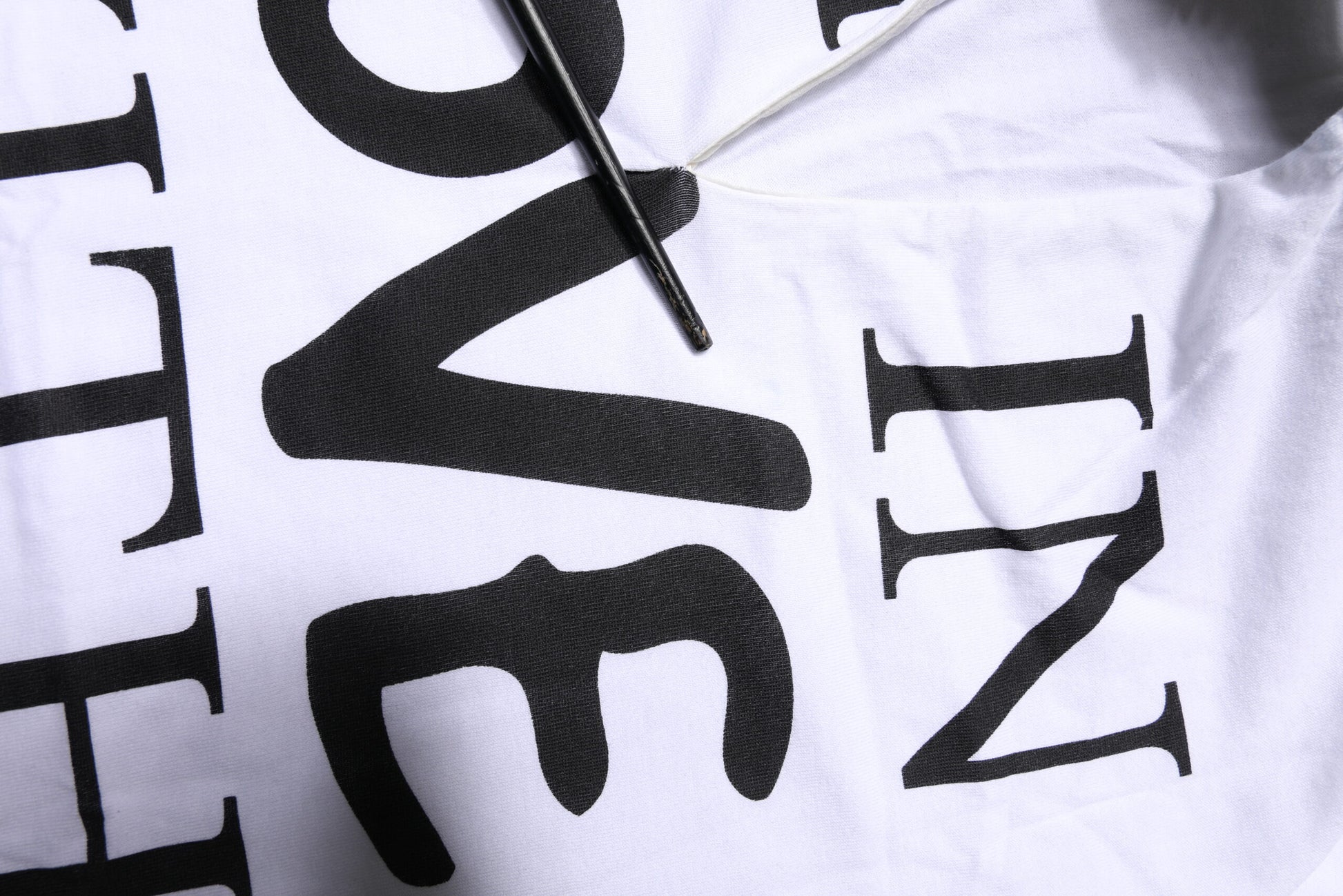 White t-shirt with black lettering