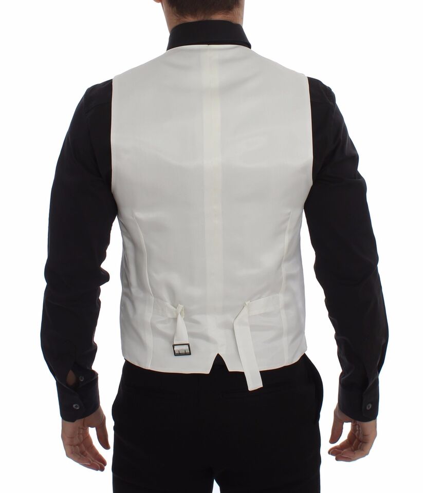 A white vest with a black shirt and tie, part of a formal outfit