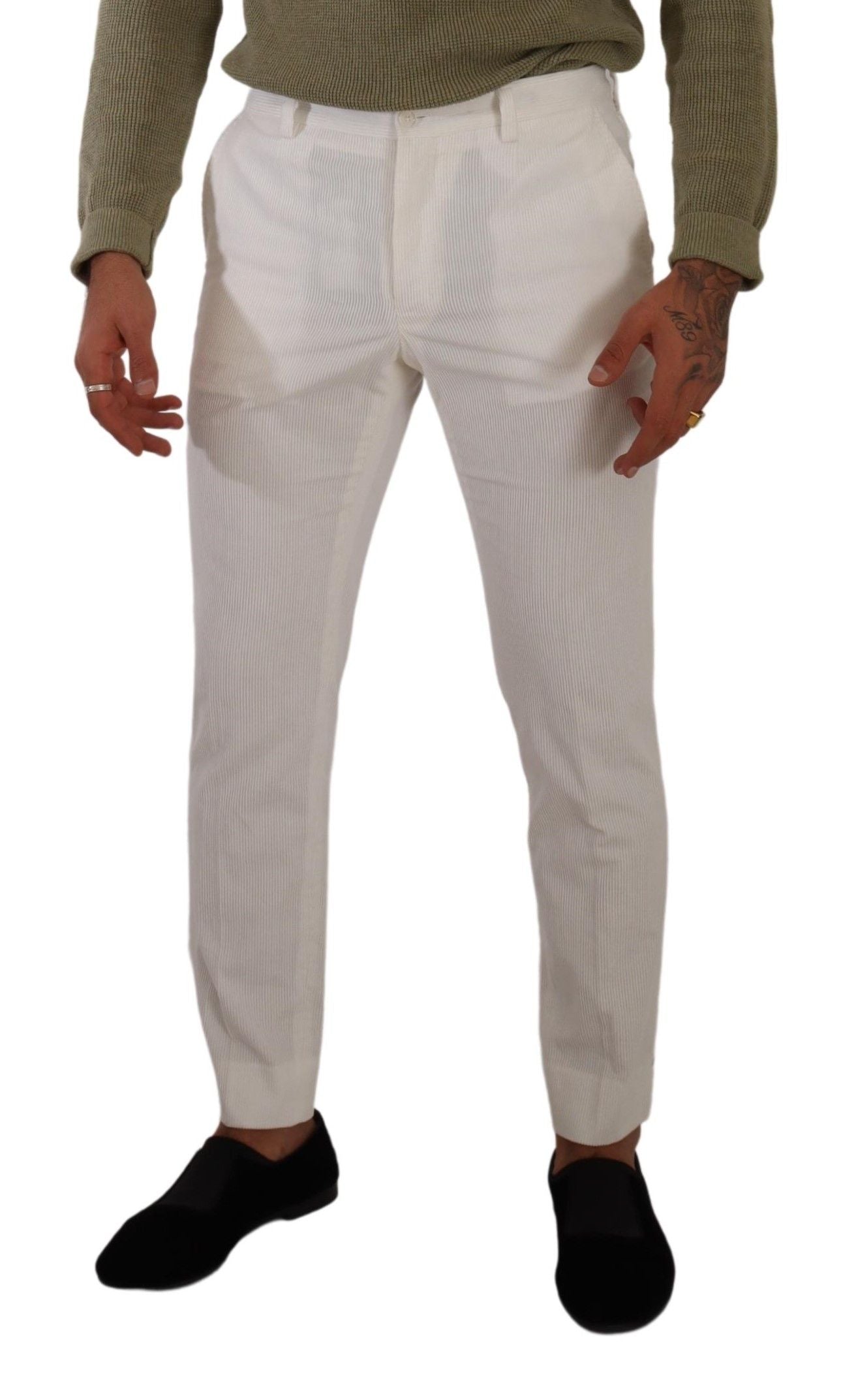 Man wearing white pants and black shoes