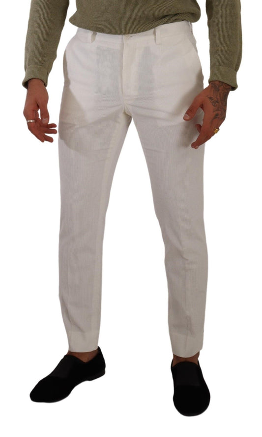 Man wearing white pants and black shoes