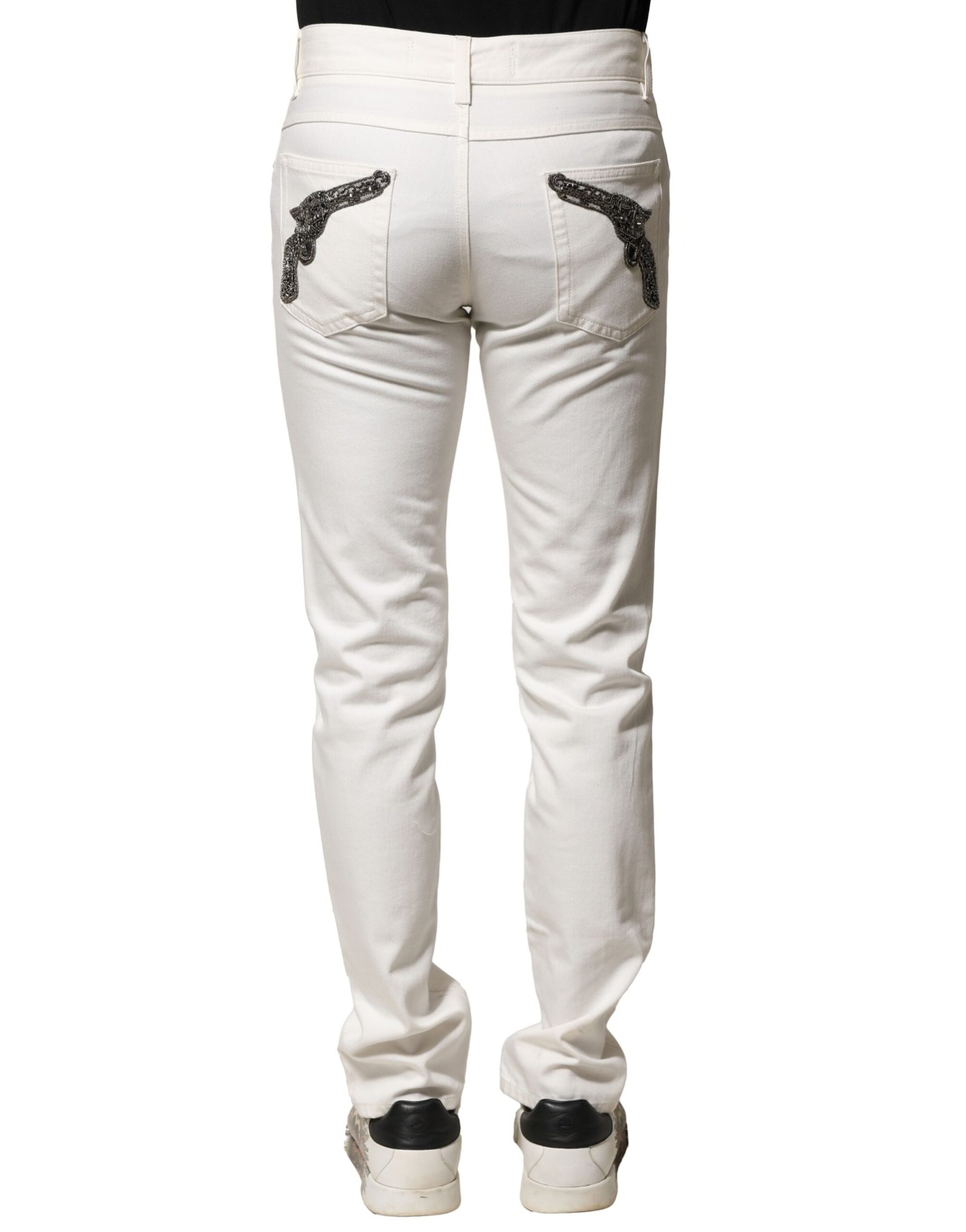 Pair of light wash denim jeans with embroidered design on back pockets