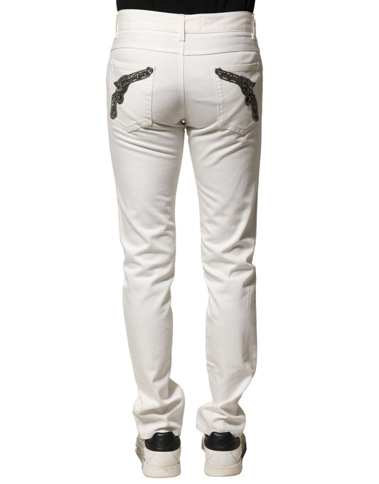 Pair of light wash denim jeans with embroidered design on back pockets