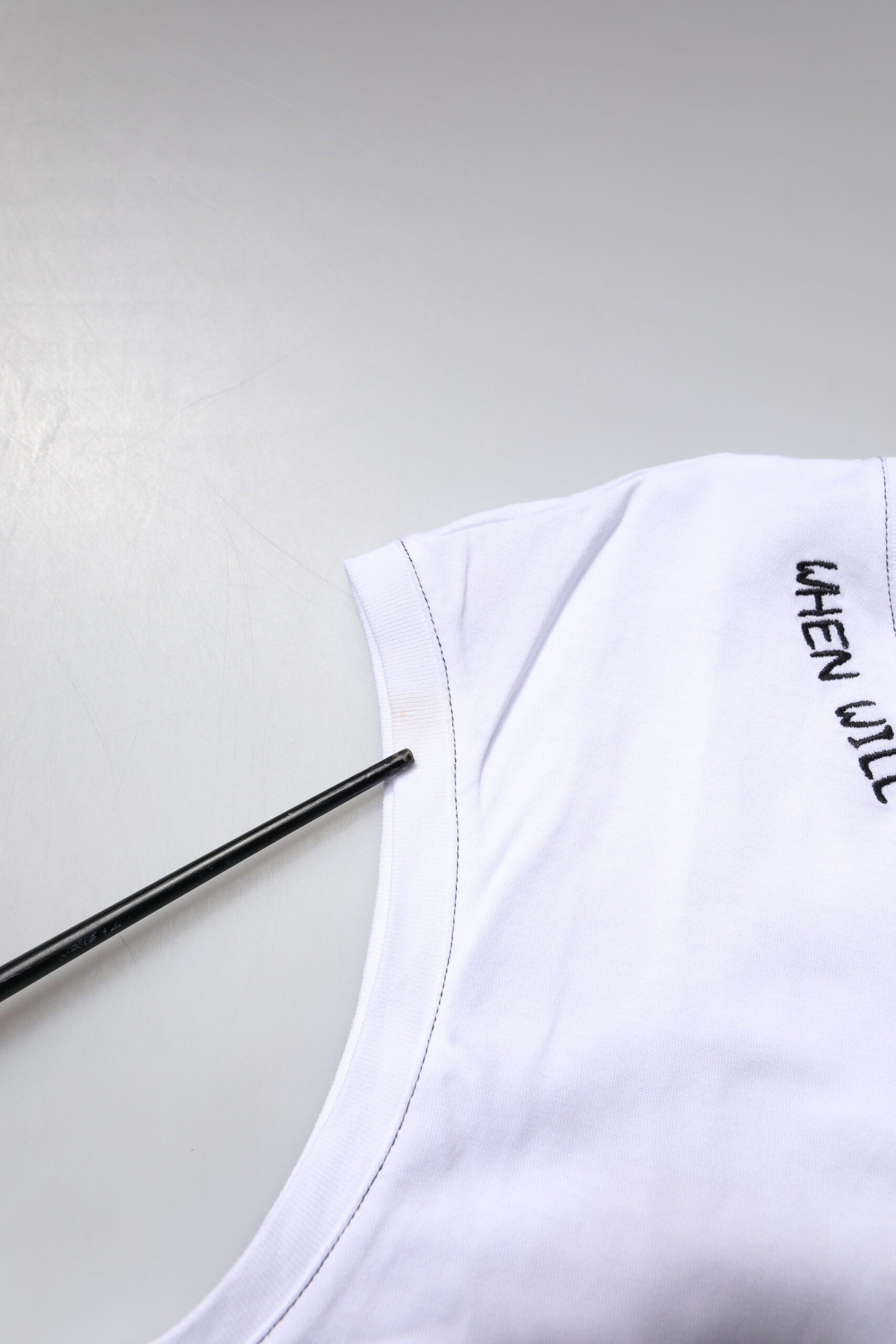 White t-shirt on a mannequin with black writing on front