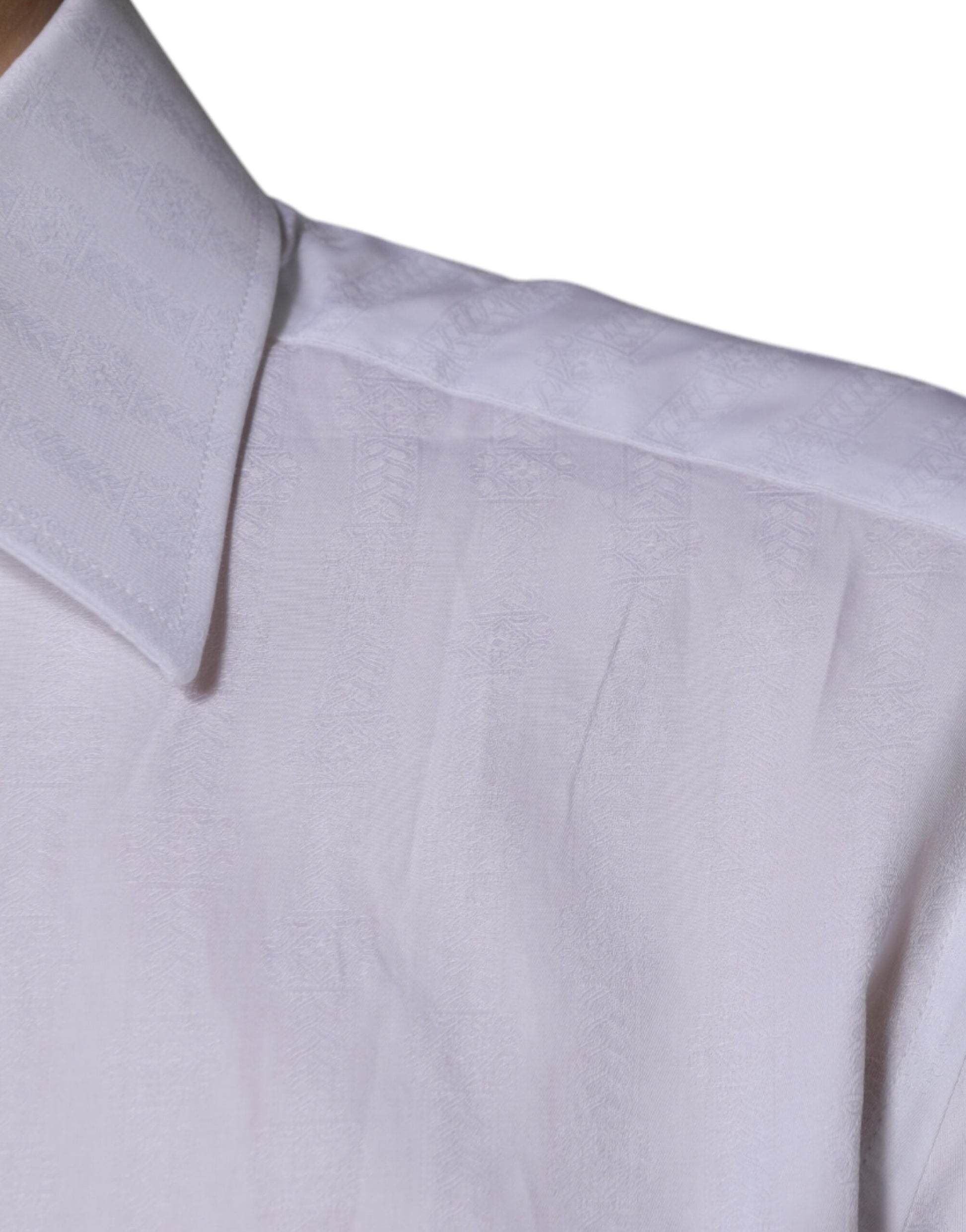A white cotton dress shirt with a slim fit and gold detailing