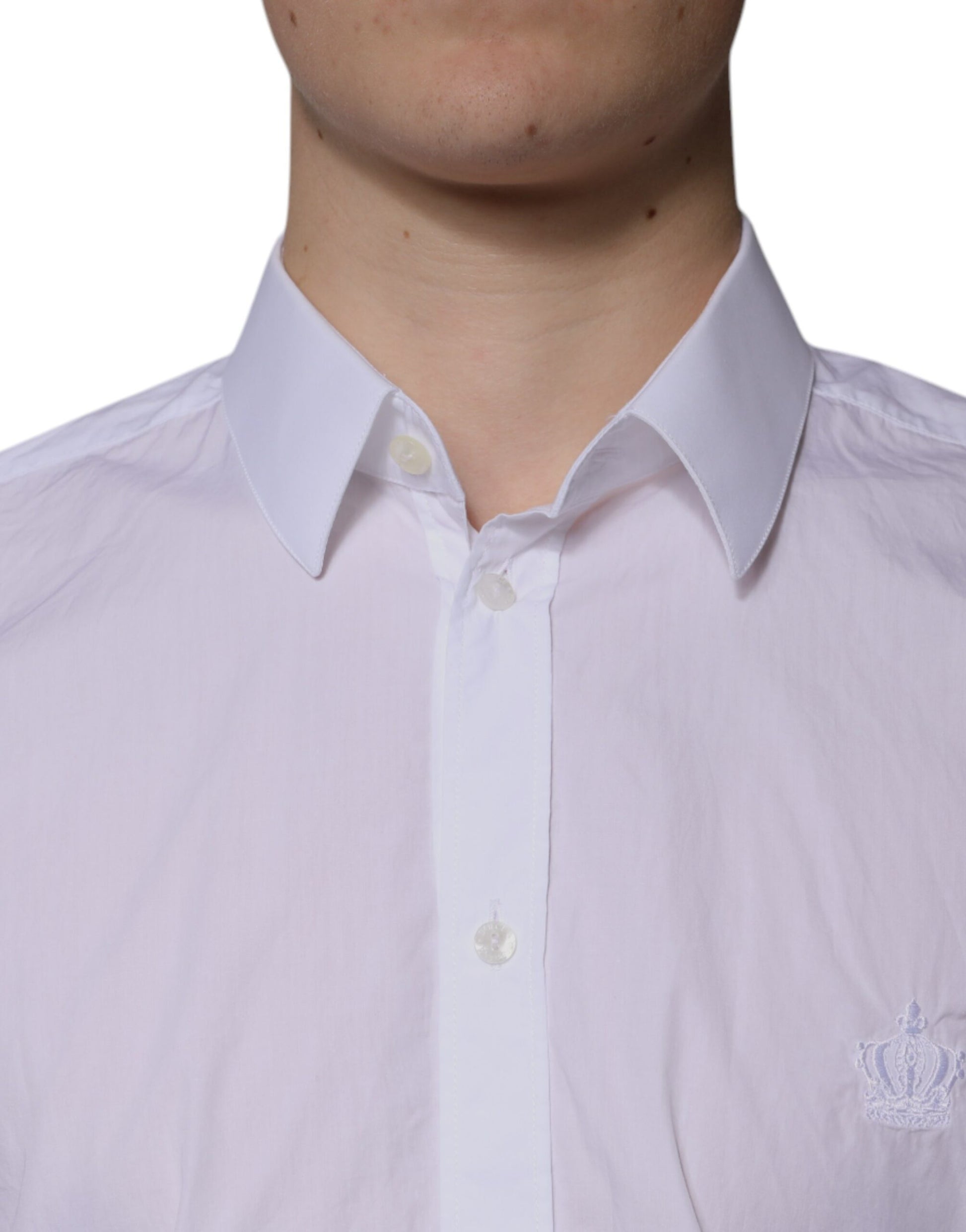 A mannequin wearing a white cotton slim fit dress shirt with a collar and buttons. The shirt has a logo on th