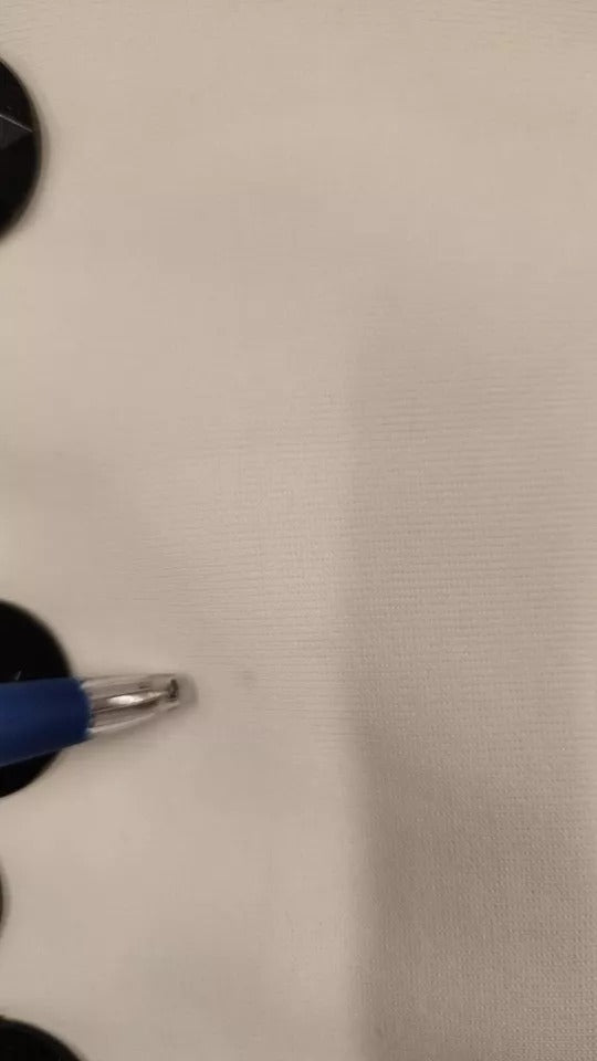 Blue pen on white fabric