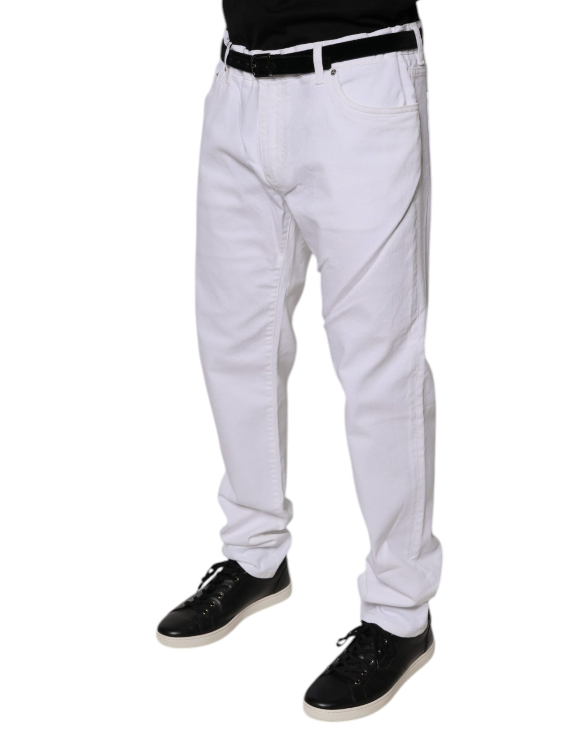 Man wearing white pants and black shoes