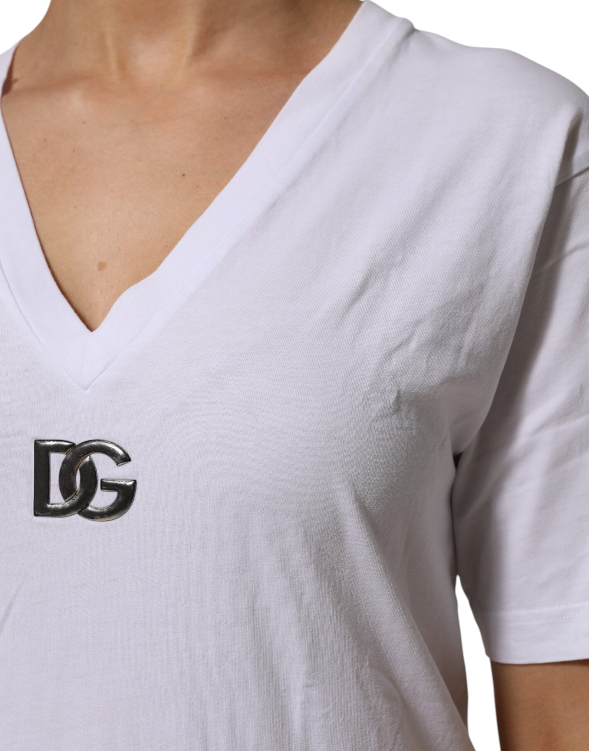White v neck t shirt with a logo on the left chest area