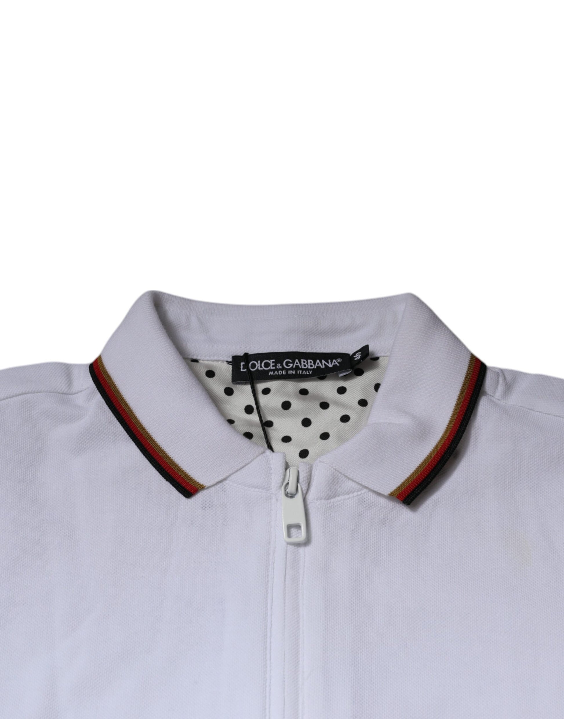 White polo shirt with red collar and black dots