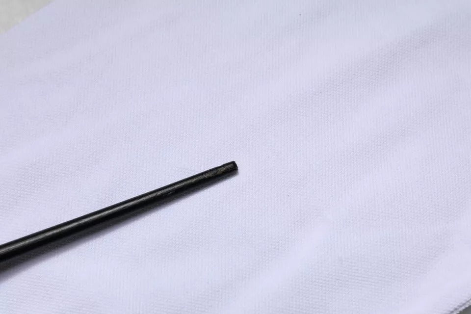 Small metal rod on white cloth