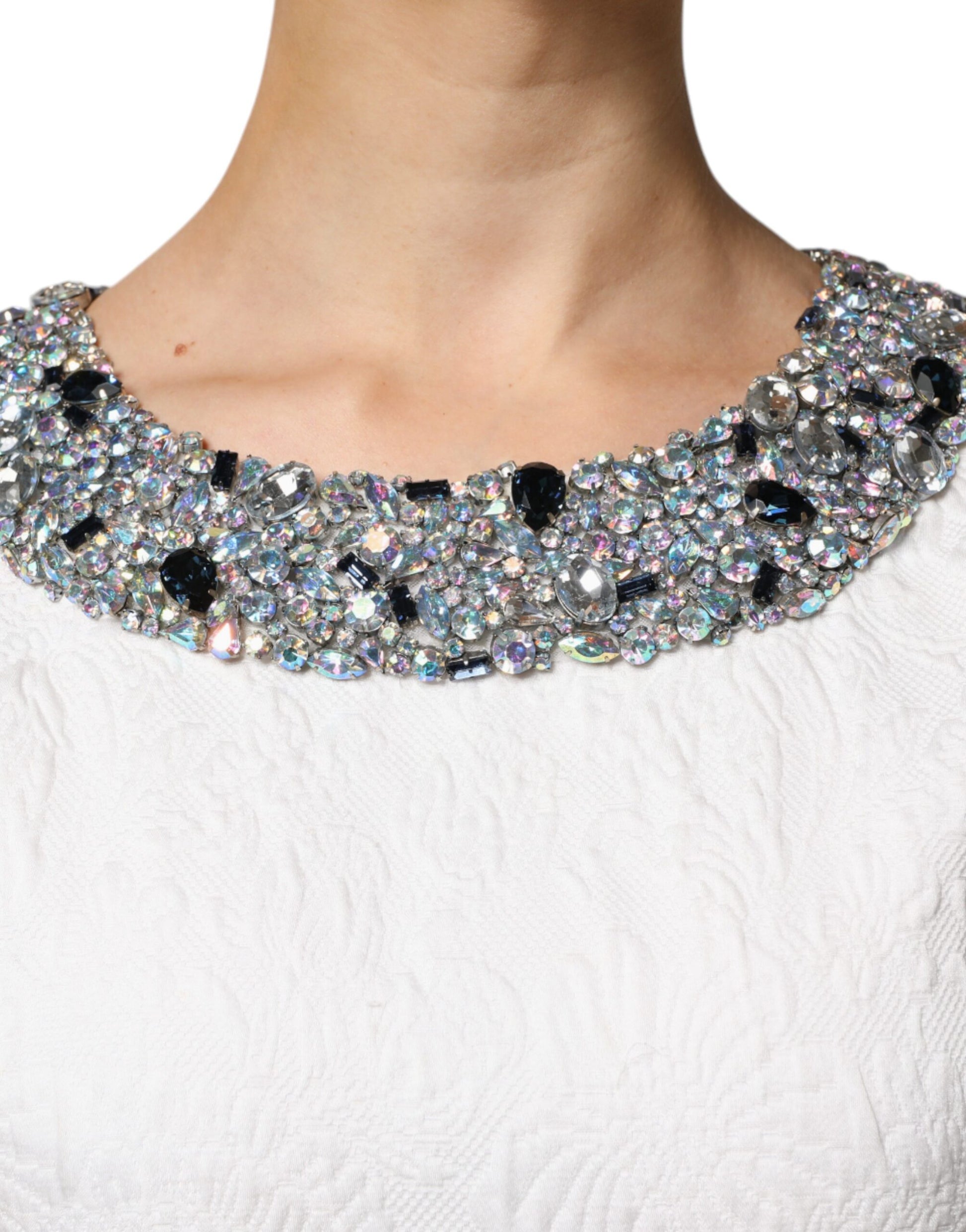 A white dress with a crystal embellished neckline and jacquard brocade pattern