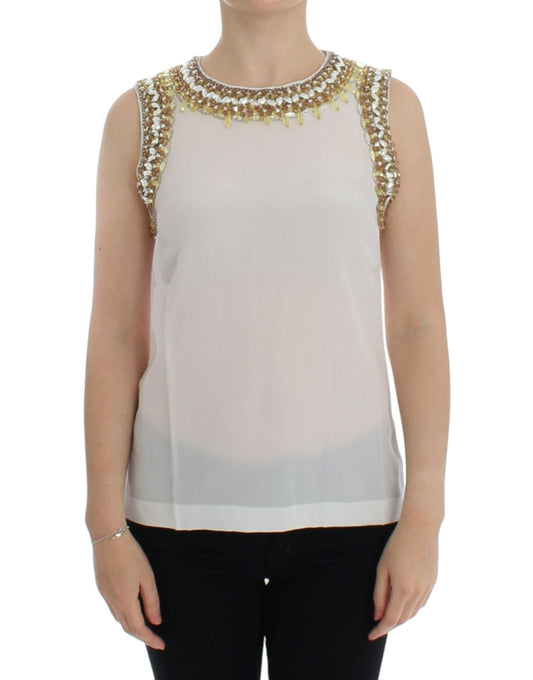 Woman wearing a sleeveless top with embellishments on shoulders