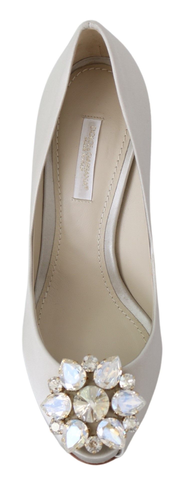 A single shoe against a neutral background. It is a women's dress shoe with a pointed toe and a strap across the top of t