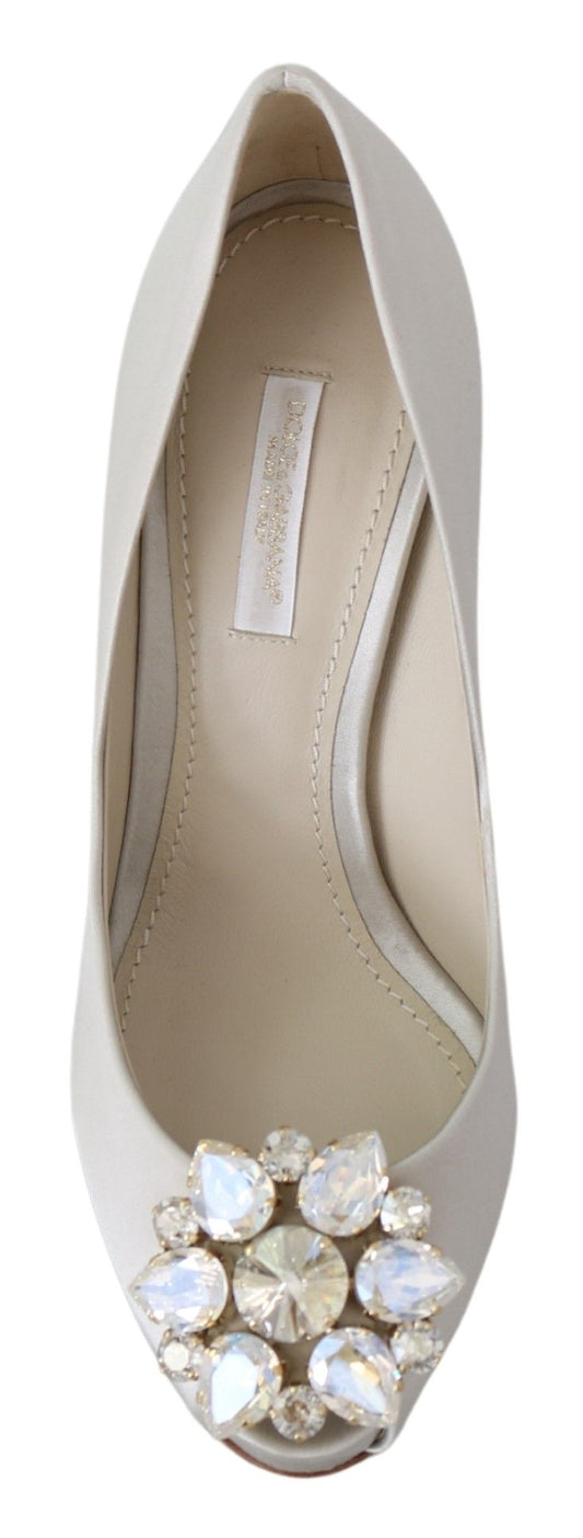A single shoe against a neutral background. It is a women's dress shoe with a pointed toe and a strap across the top of t