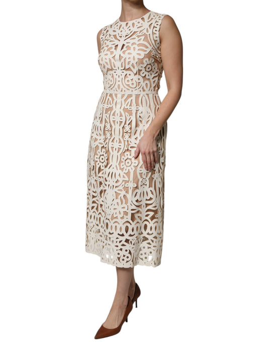 A white midi dress with cut out details and a sleeveless design