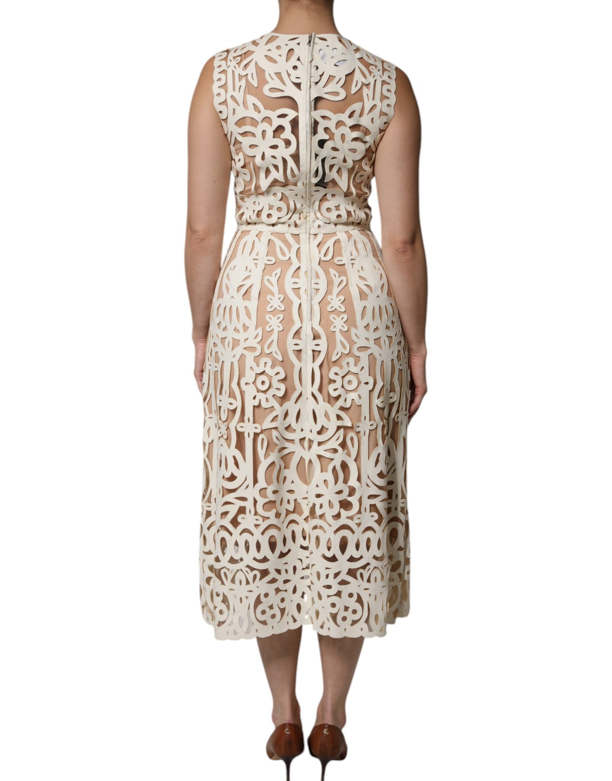 A sleeveless midi dress with cut-out designs and a leather texture