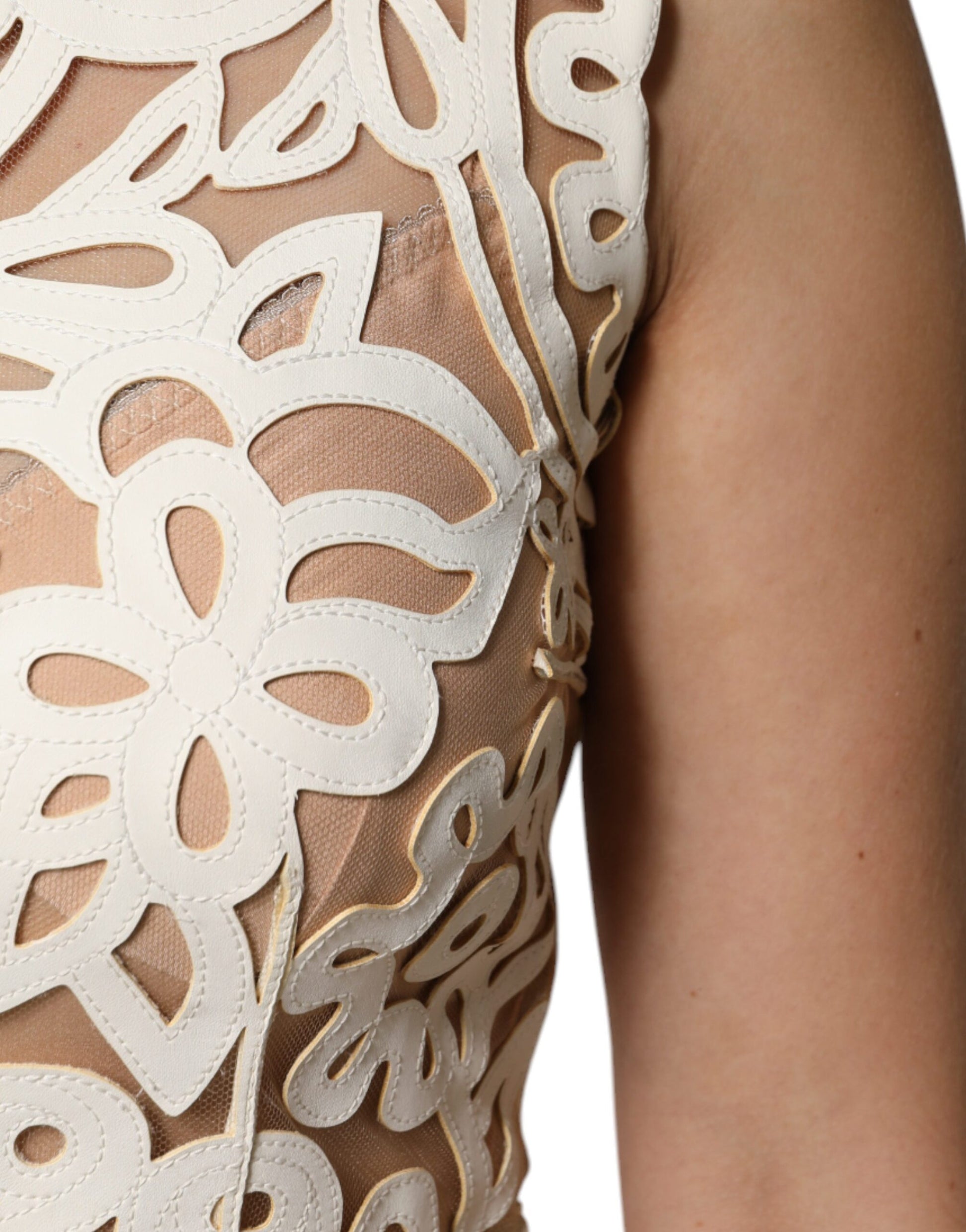 A sleeveless midi dress with cut-out designs and a white leather texture