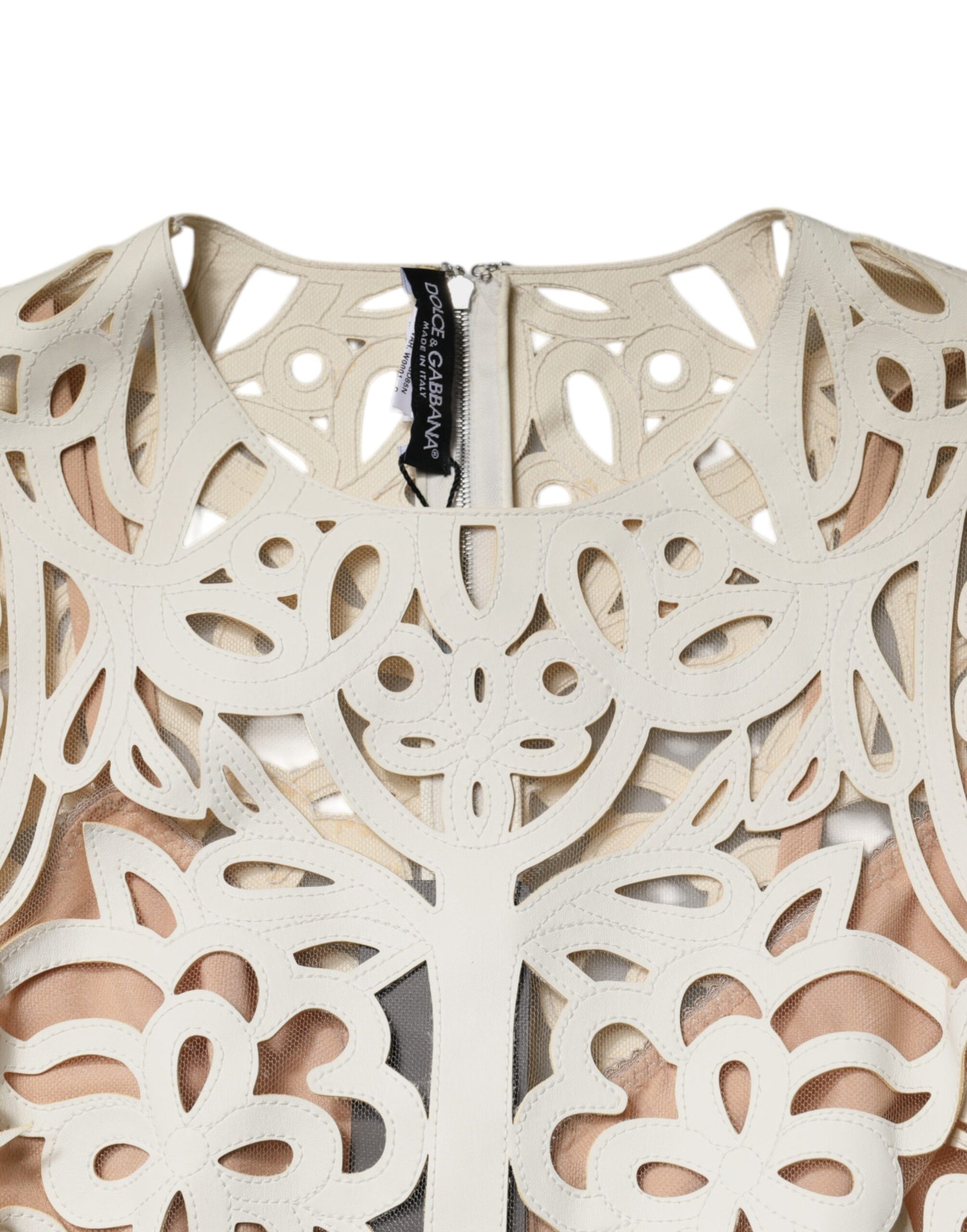 A sleeveless midi dress with cut-out designs and a leather texture