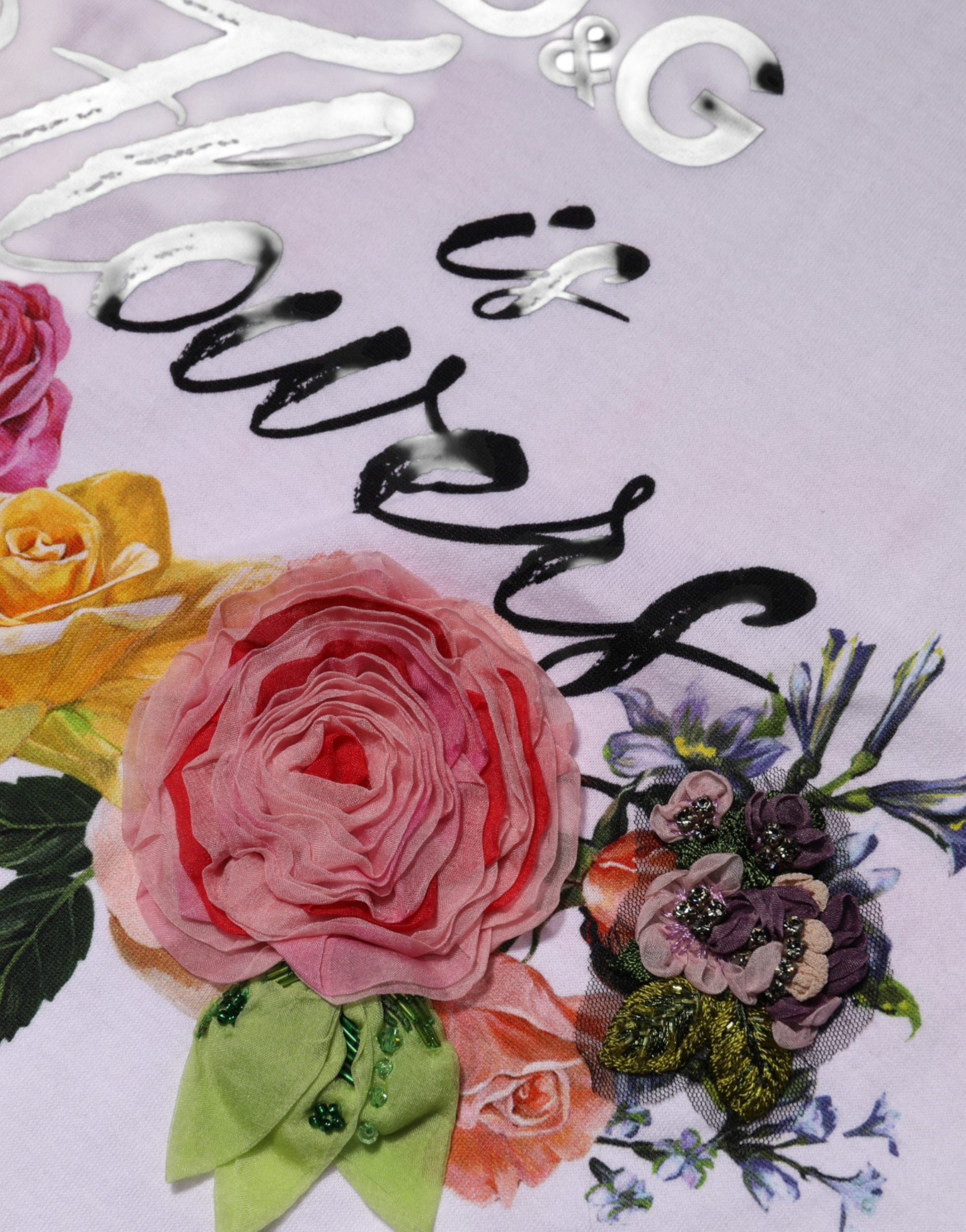 Floral embroidered fabric with pink roses and greenery