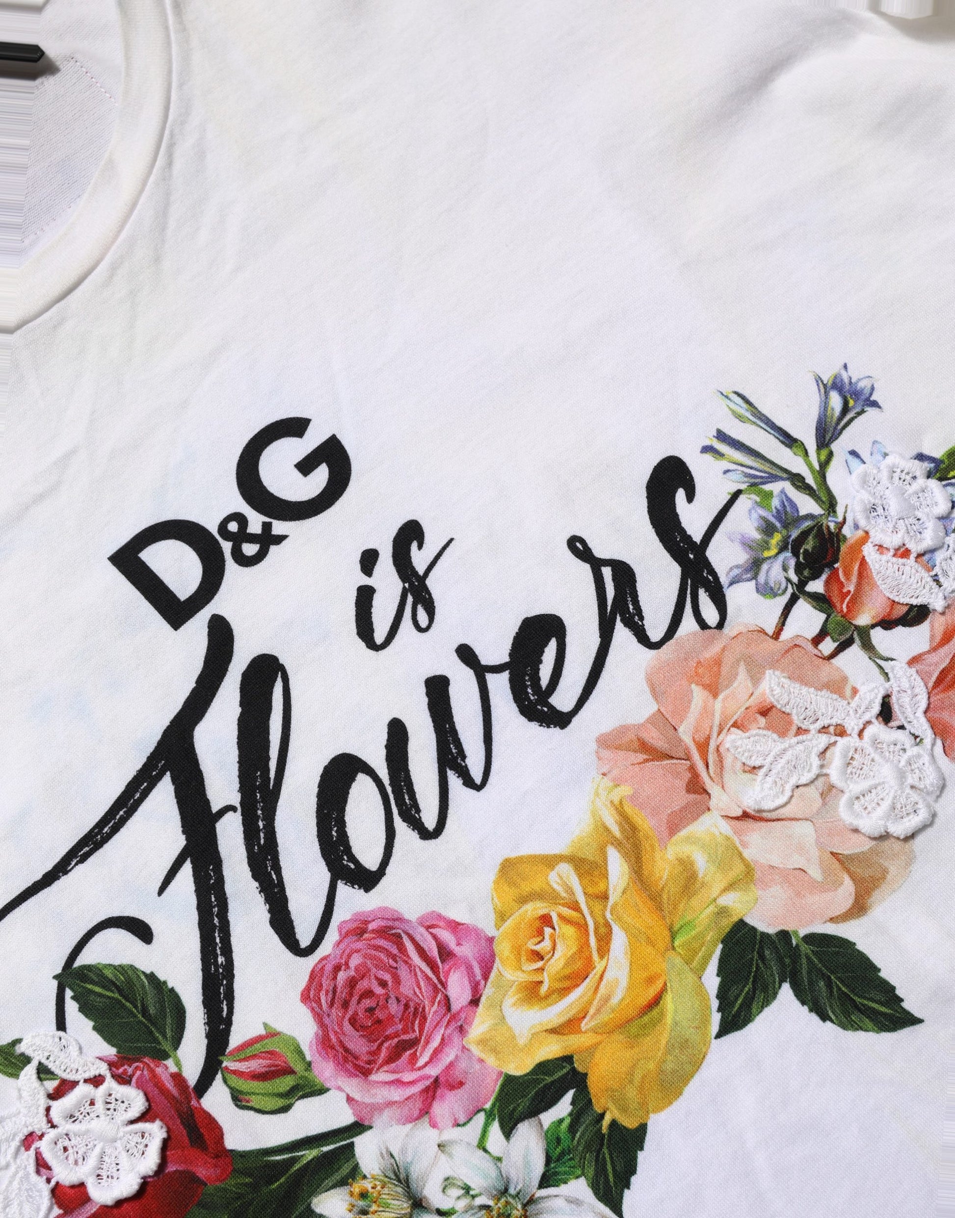 A white t-shirt with a floral print and the text "D&G is Flowers" written in black