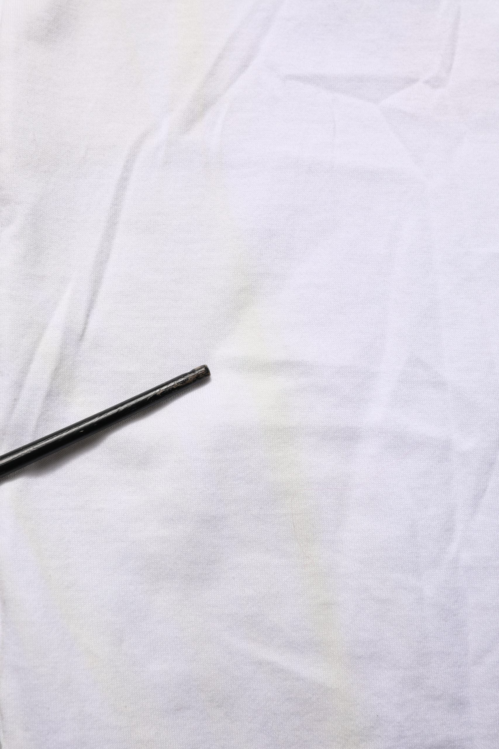 A black pen on a white t-shirt with a floral print
