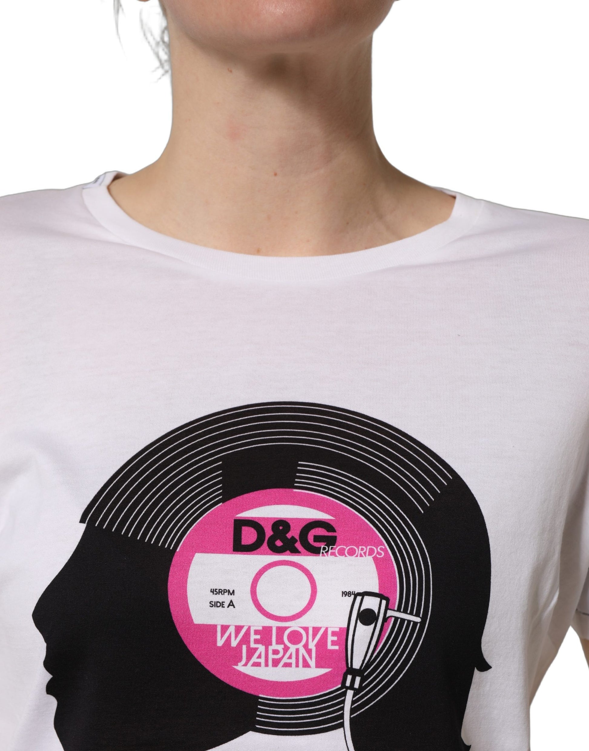 A white t-shirt with a graphic print of a vinyl record and headphones, featuring the text "WE LOVE JAPAN" in pink