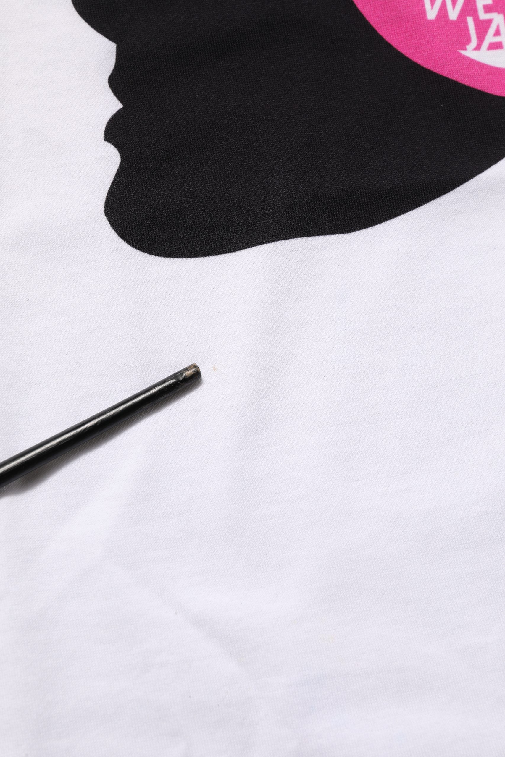 A white t-shirt with a print of a face and text