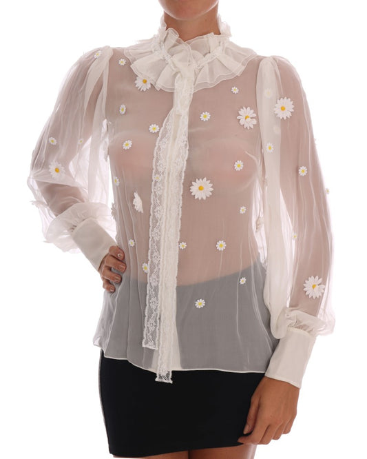 Woman wearing a sheer blouse with daisy embroidery