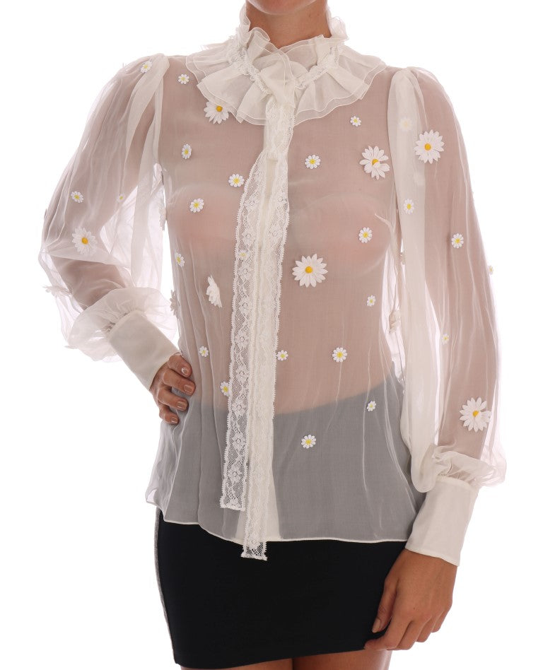 Woman wearing a sheer blouse with daisy embroidery