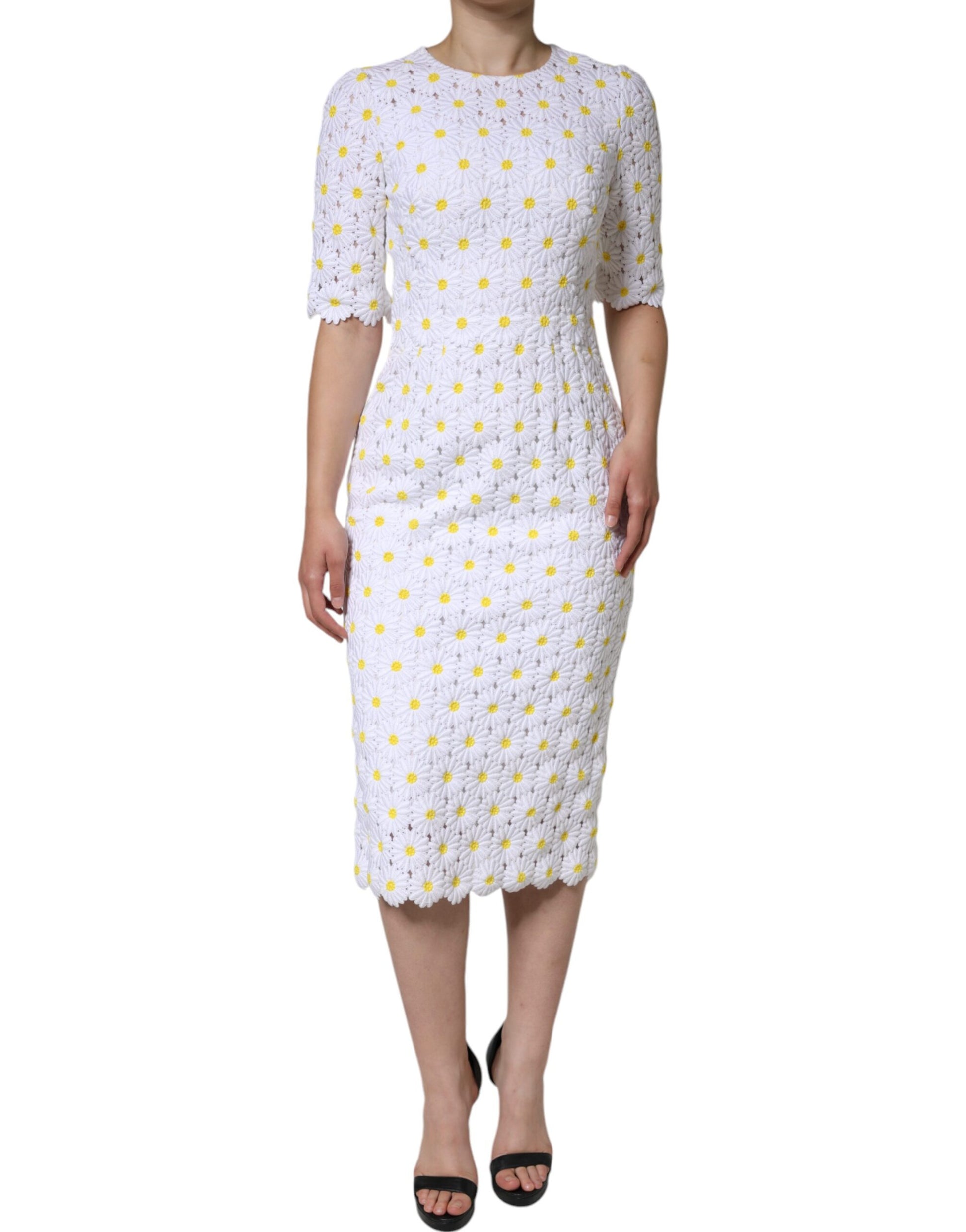 A white midi dress with a lace bodice and macramé daisy pattern
