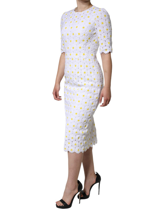 A white midi dress with macramé lace and daisy embroidery