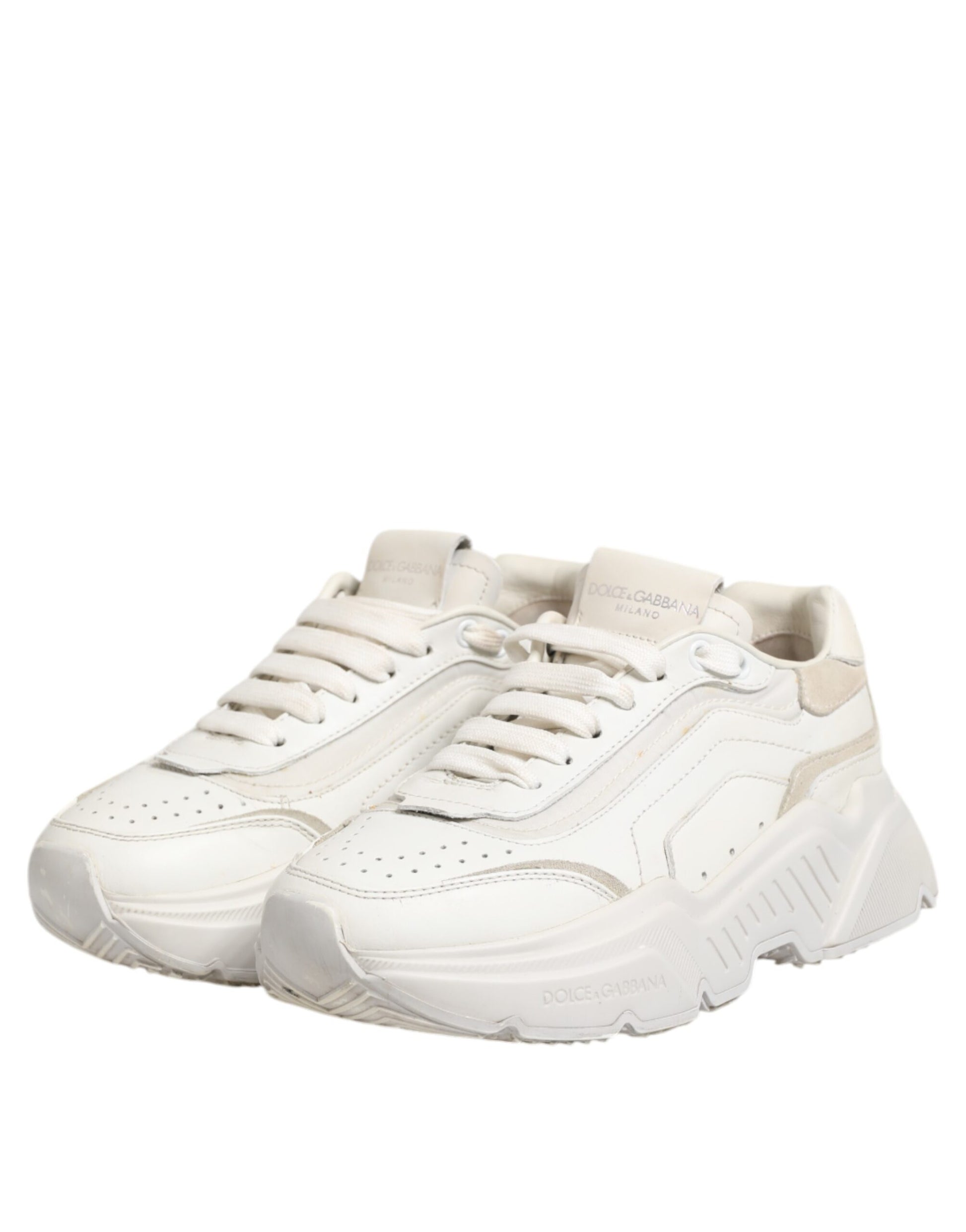Pair of white sneakers with black stripes on sides