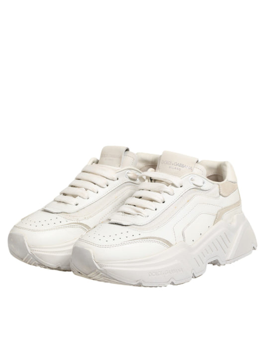 Pair of white sneakers with black stripes on sides