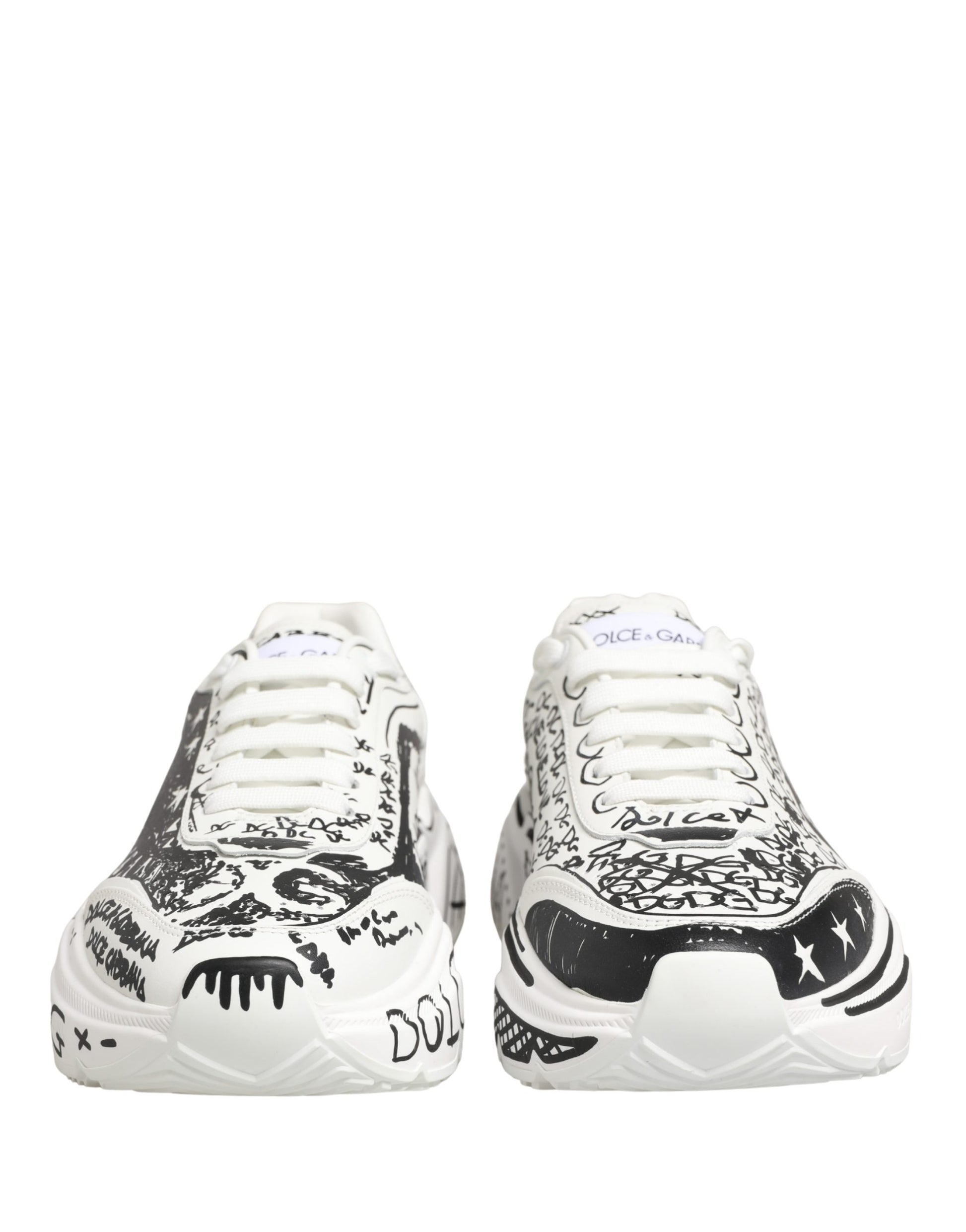 Pair of white sneakers with graffiti design and black laces