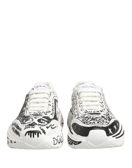 Pair of white sneakers with graffiti design and black laces