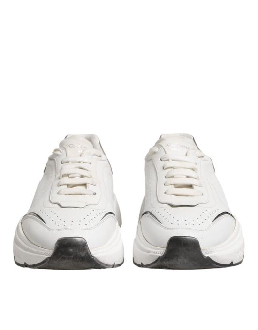 Pair of white leather sneakers with black laces and a small logo on the side