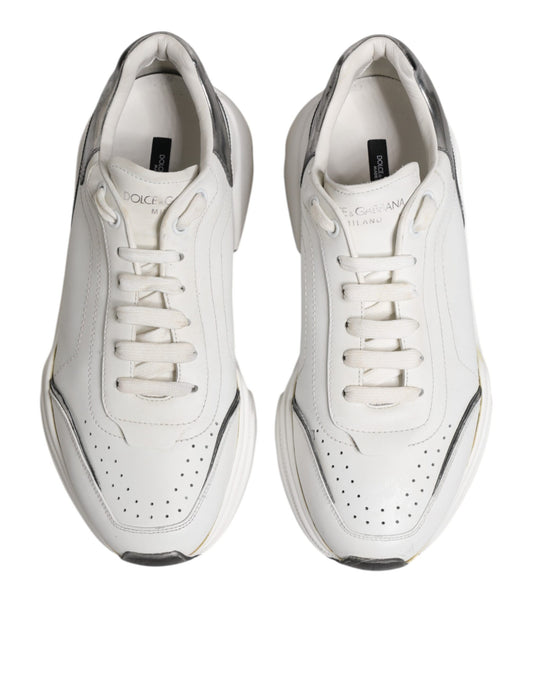 Pair of white leather sneakers with black laces and logo, low top style