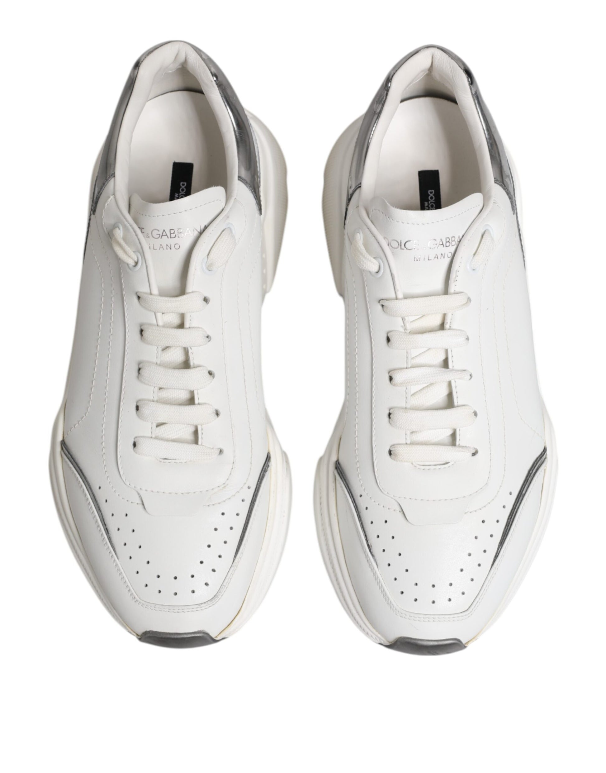 Pair of white leather sneakers with black laces and a small logo on the side