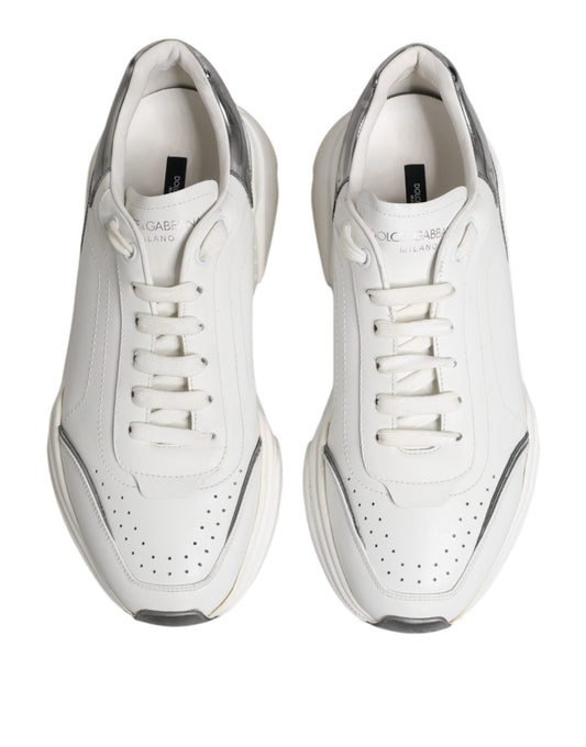 Pair of white leather sneakers with black laces and a small logo on the side