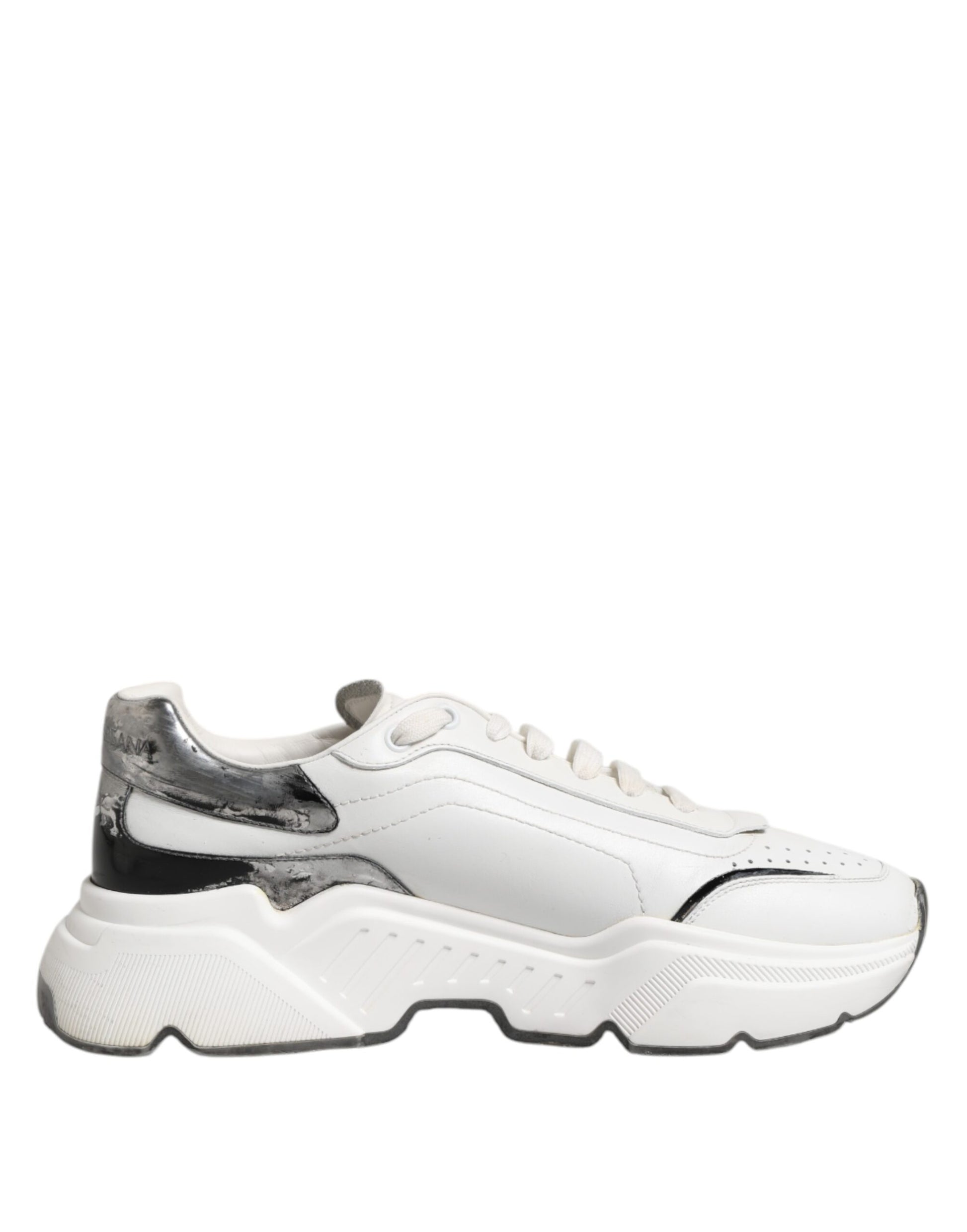 A pair of white leather sneakers with black accents, featuring a low top and a chunky sole design