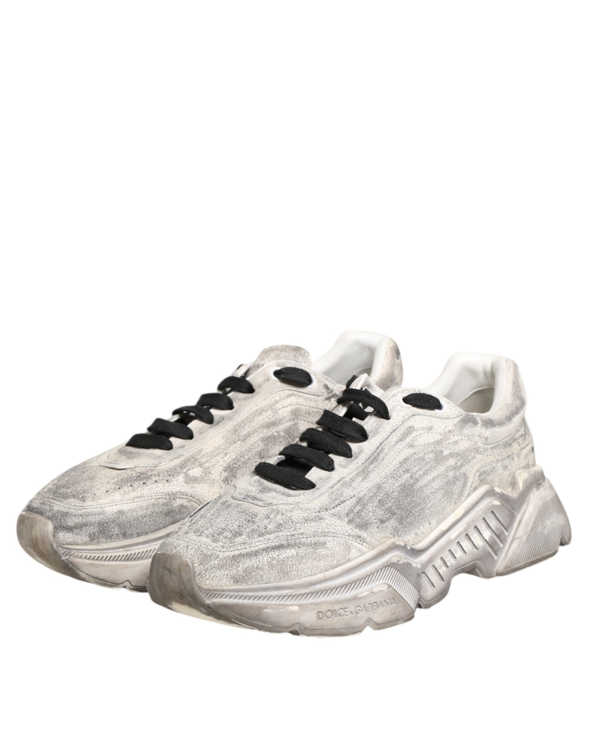 A pair of white sneakers with black laces, featuring a glittery texture and the brand logo on the side