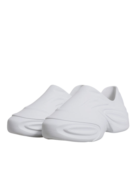 Pair of white sneakers with laces and a logo on the side