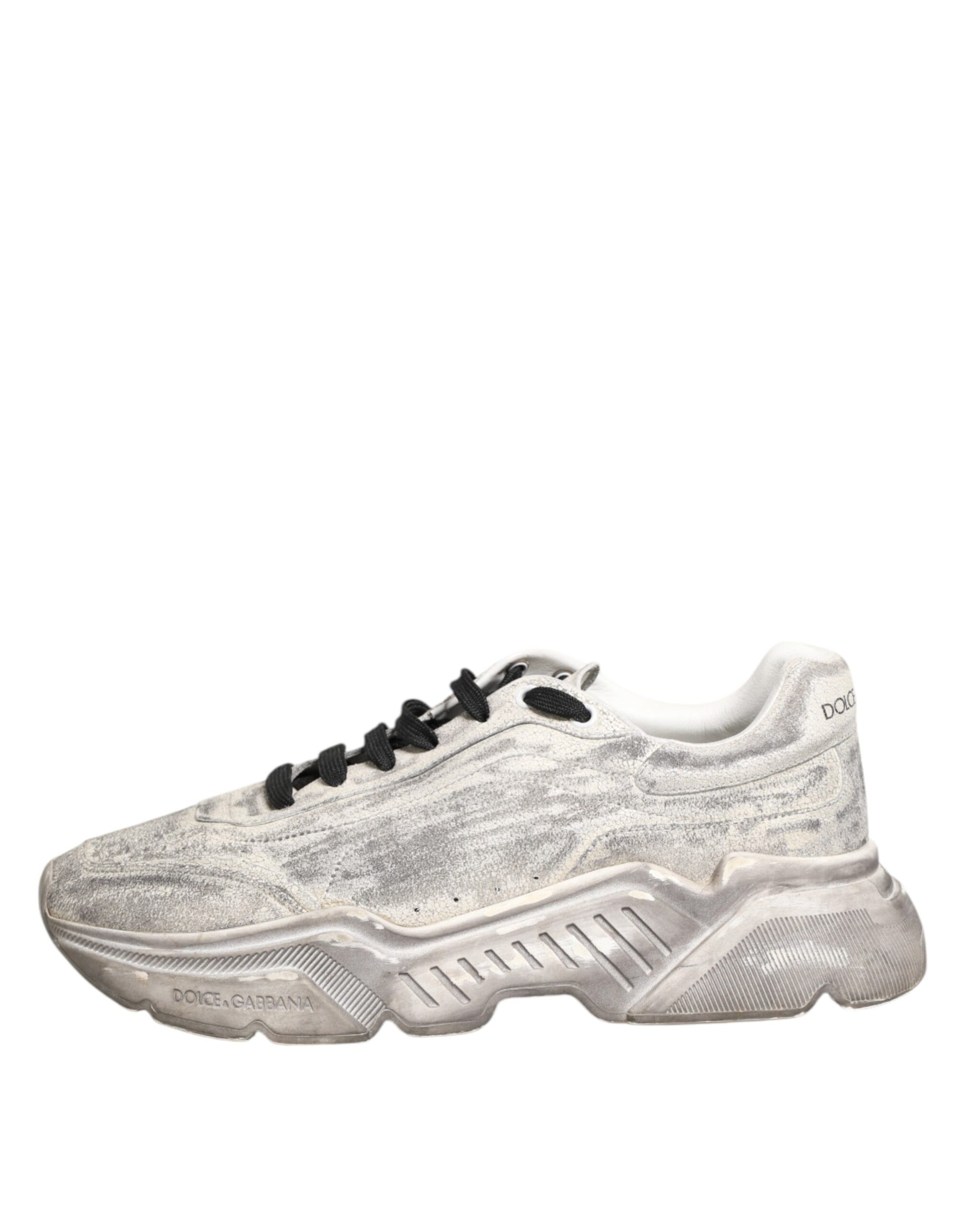 A pair of white sneakers with a glittery texture, featuring the brand name "Dolce & Gabbana" on the side