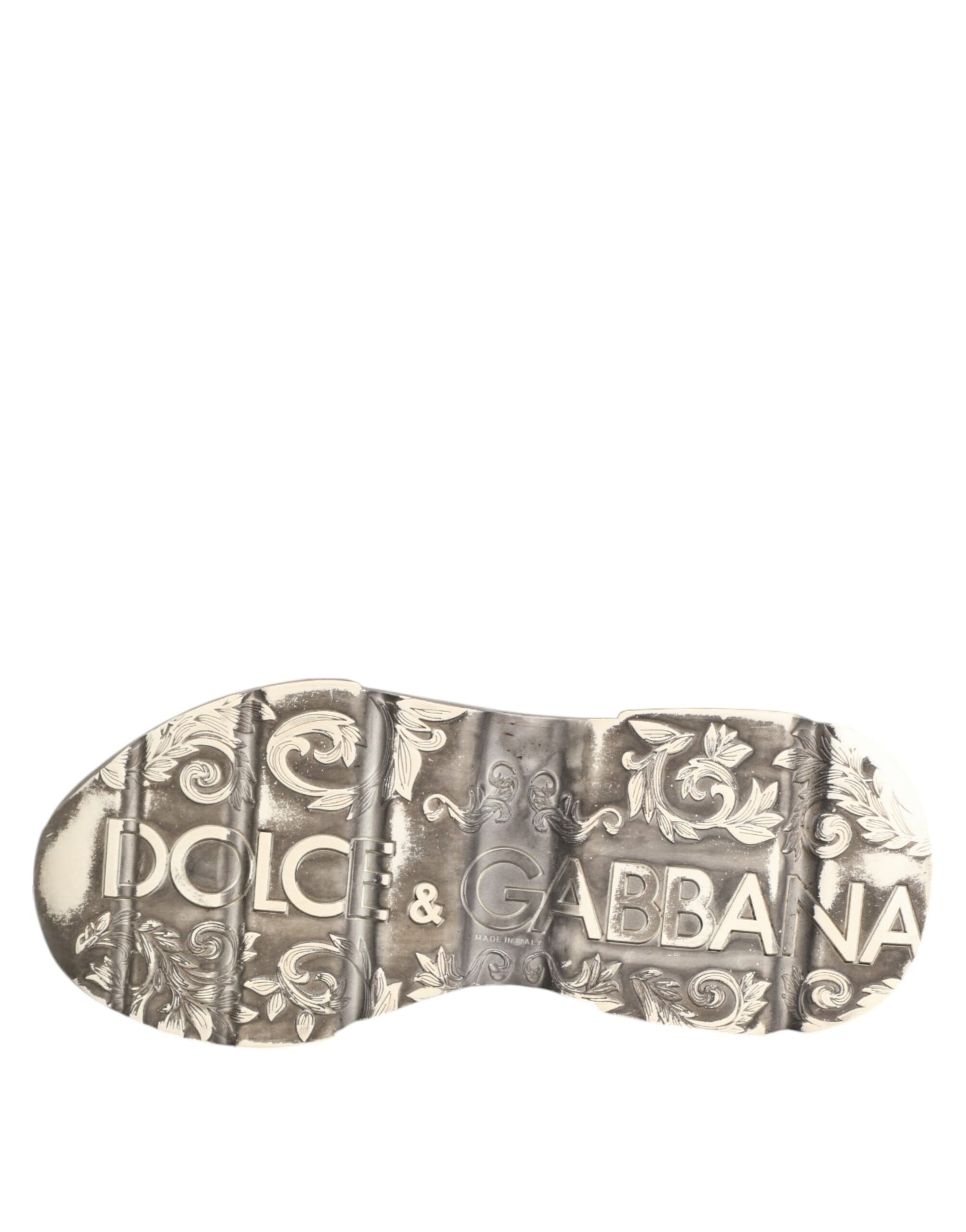 A pair of white sneakers with gold accents, featuring the Dolce & Gabbana logo