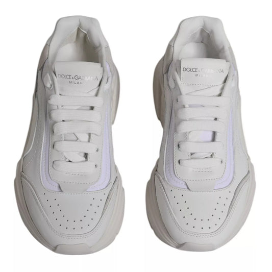Pair of white sneakers with pink accents, featuring brand name and logo on side panels