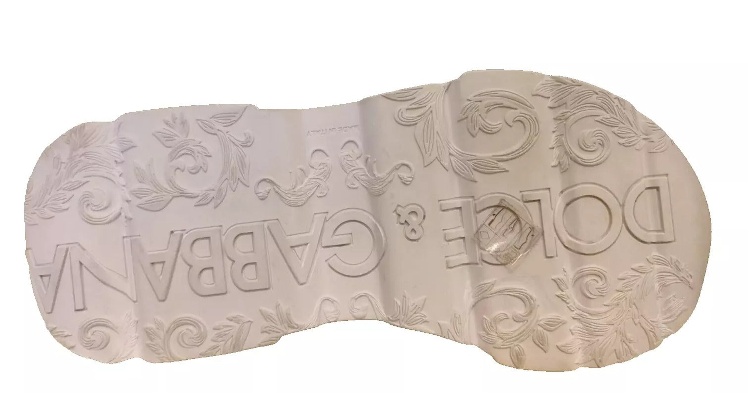 A pair of white sneakers with a floral pattern on the side and the word "Dolce & Gabbana" written across them